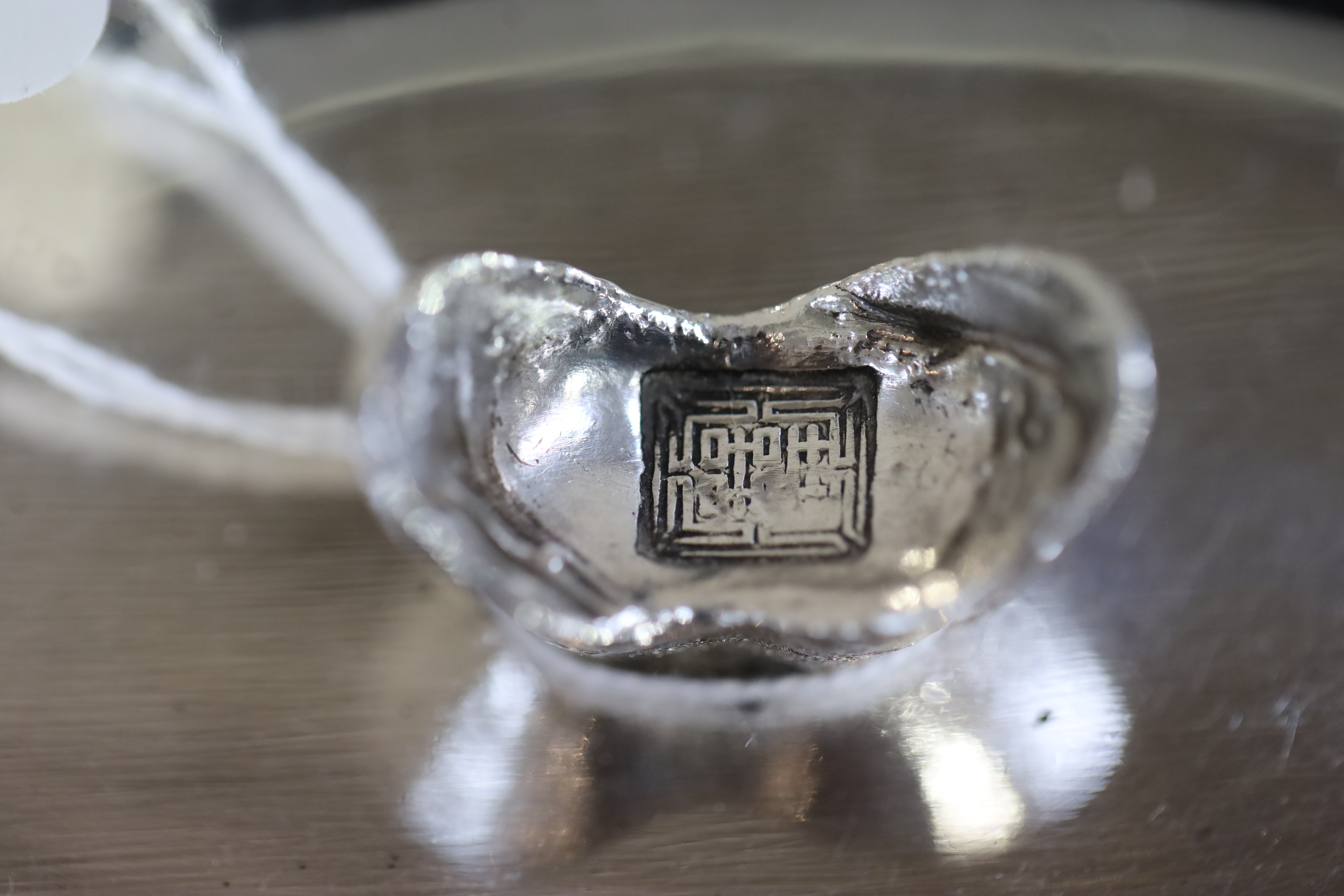 A Chinese white metal oval pen rest by Wai Kee, 12.7cm, 3.5 oz,
